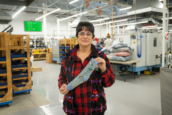 Kim holding up her favorite sock, the Twitterpated, which has adorable birds on it