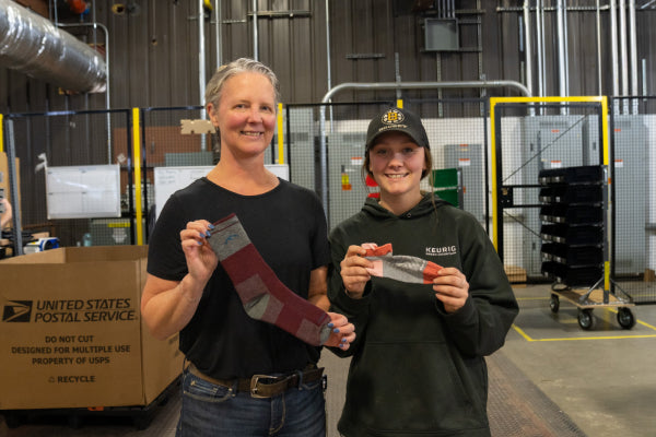 Jody and Brianna showing the socks they each picked as the perfect mom gift