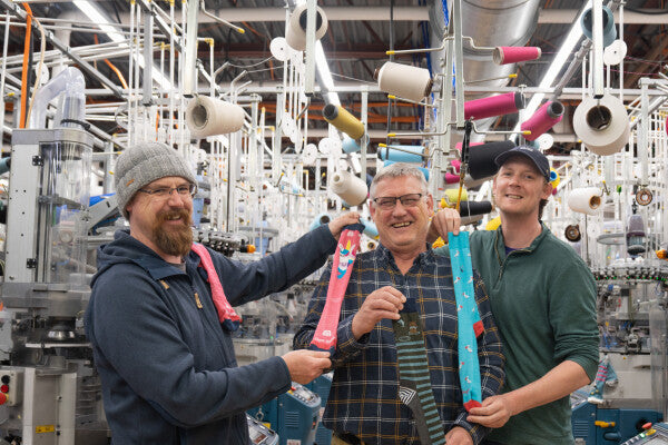 Two sons teasing their dad they'd give him a pink child's socks