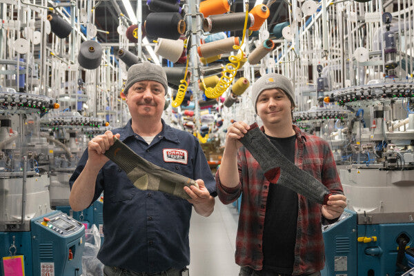 Jay and Lucas smiling while showing off socks for dad