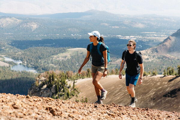 Two hikers headed up a ridge wearing merino wool socks for hiking