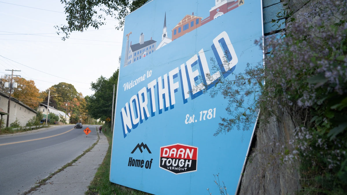 A sign saying "welcome to Northfield home of Darn Tough Vermont"