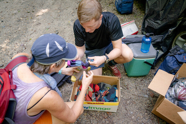 Thru hiker and Darn Tough volunteer looking through a box of fresh socks