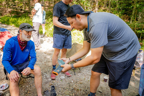 A Darn Tough volunteer explains sock features to a thru hiker