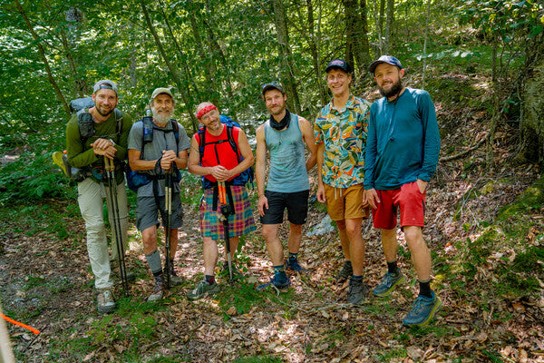 A group of thru hikers smiling wearing new darn tough socks