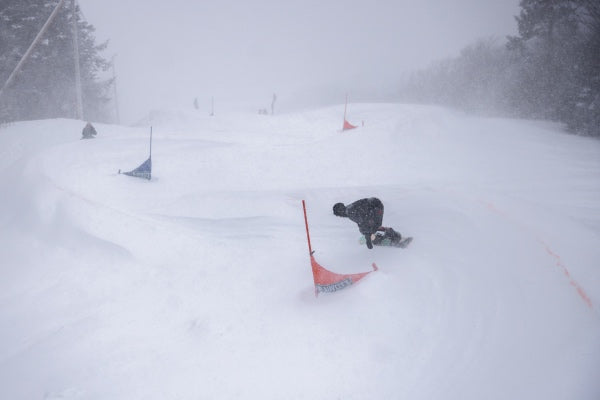 Looking down the snowboard race course with a rider one it