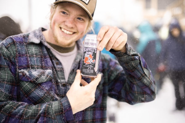 A racer proudly holding up a local brew supporting Blauvelt Banks