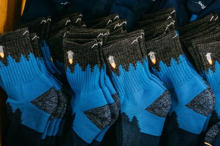 Stacks of the Number 2 Merino Wool hiking socks in blue and gray