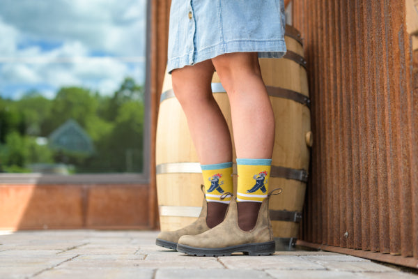 Person standing in Darn Tough cat socks