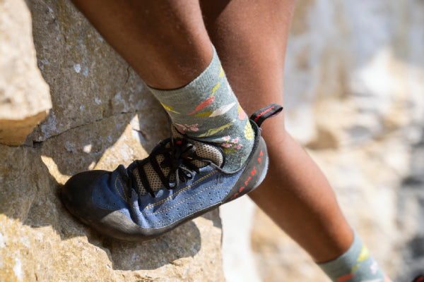 Model Rock Climbing with Darn Tough socks and Climbing Shoes