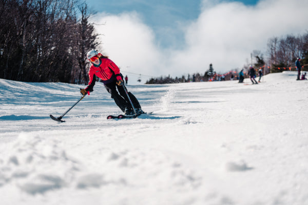 An adaptive skier coming down the mountain