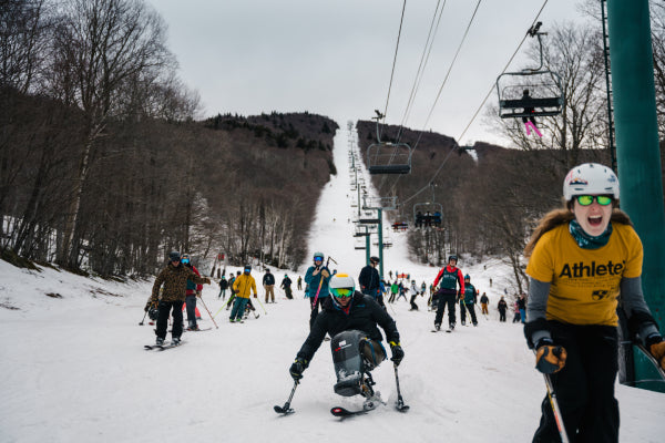 The crowd of skiers coming down for the party lap