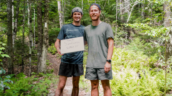 See Far and Sand Worm, thru hikers, holding a sign saying "SOBO 2022"