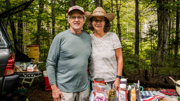 Jeff and Nancy, true trail angels, standing by their trail magic table laden with food