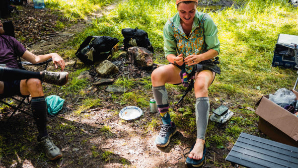 Excited thru-hiker pulling on a brand new pair of Darn Tough socks