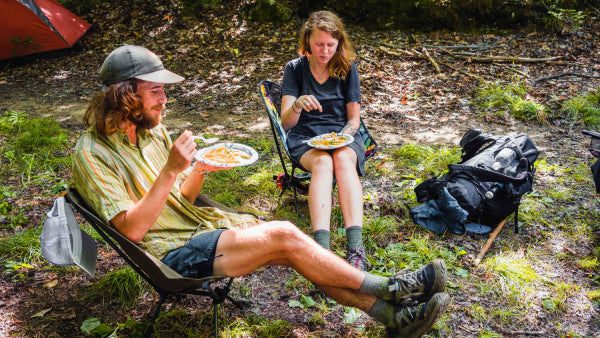 Two thru hikers experiencing trail magic, a hiker feed of yummy food