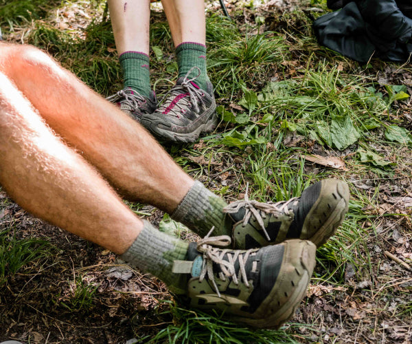 Two pairs of thru hiker feet in darn tough hiking socks