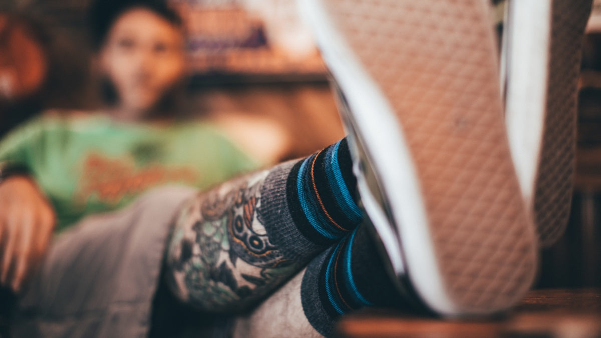 Dad with feet up showing off his darn tough socks, a great Father's Day gift