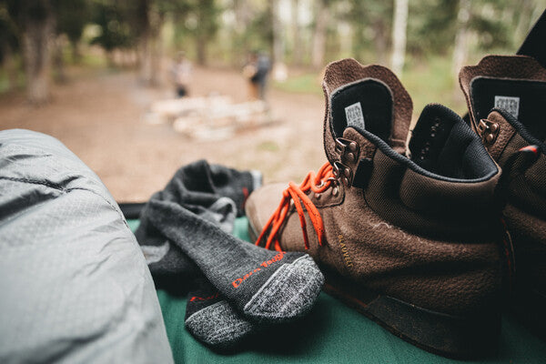 Merino wool anti stink hiking socks next to hiking boots