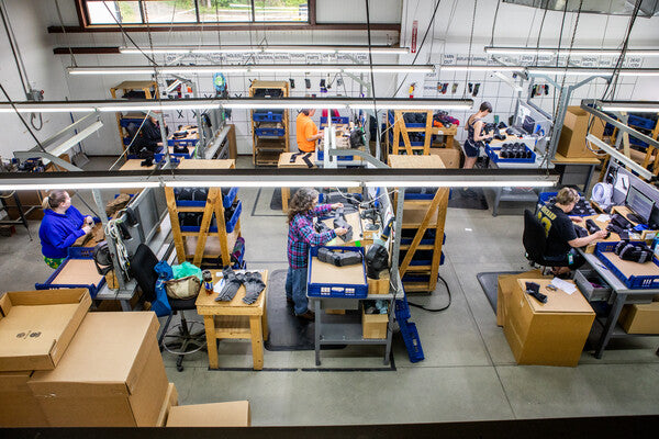 Rows of workers checking the quality of Darn Tough socks