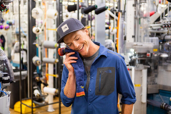 Jake at the Mill hugging a merino wool sock