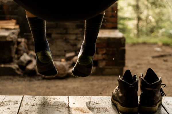 Hiker seated in hammock wearing darn tough socks