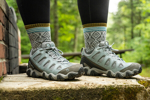 Closeup of woman wearing hiking shoes and micro crew hiking socks