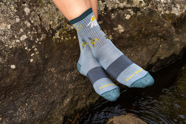 Close up of feet wearing the Queen Bee hiking socks in blue
