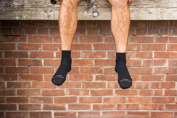 Big wide feet in black tactical socks, which fit perfect