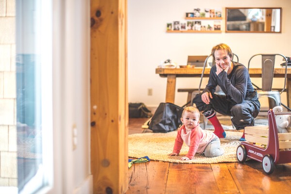 Jake Blauvelt at home playing with his child after a day spent snowboarding