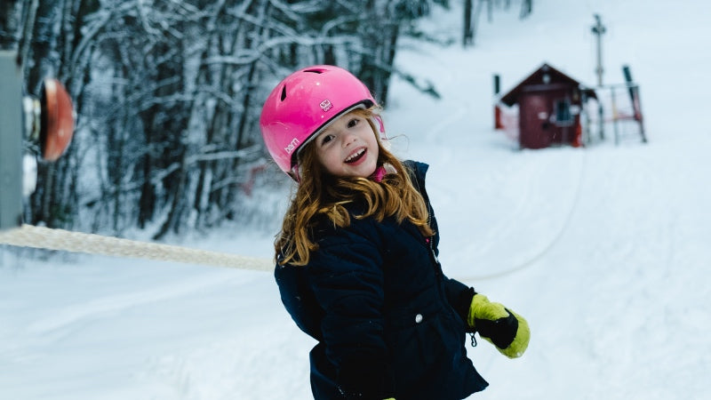 A young girl out skiing with a huge smile