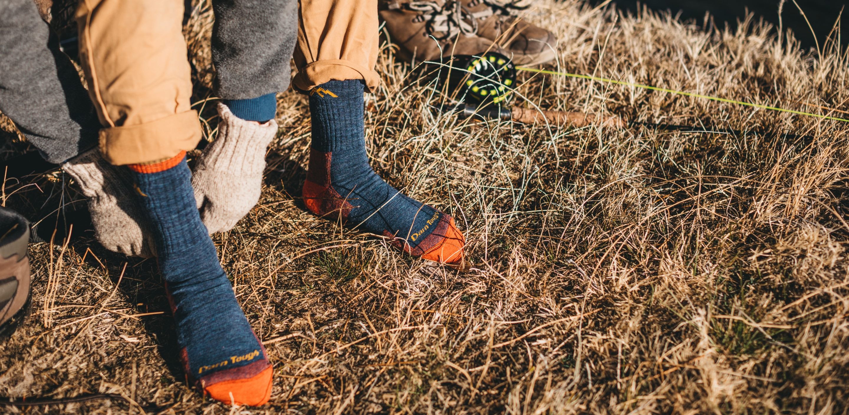 a man pulling on darn tough hiking socks, a great gift for dad