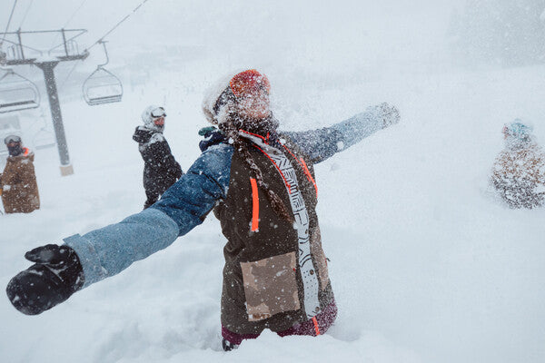 Skier standing hip deep in the snow as more snow falls at the resort