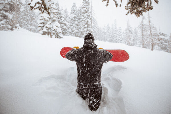 Snowboarder wading through the snow to be the first on fresh powder