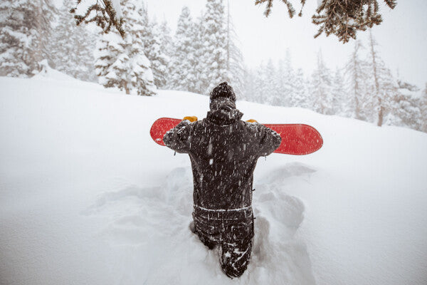 Snowboarder wading through feet of powder on the perfect snow day