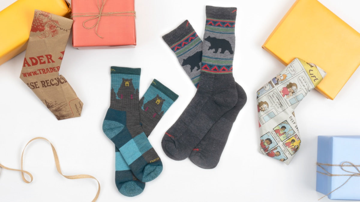 Darn tough socks with bears on them next to Christmas presents, because socks are a great gift