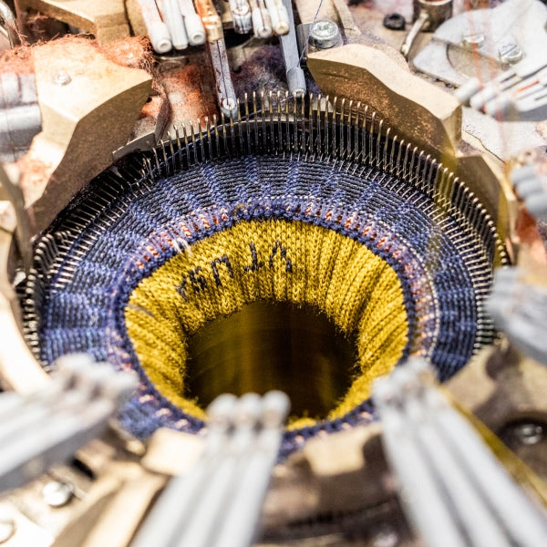 The inside of our knitting machine, showing all 168 needles knitting tiny stitches