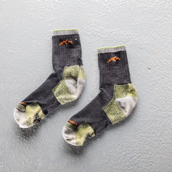 A warrantied pair of darn tough hiking socks, well-worn and giving us feedback