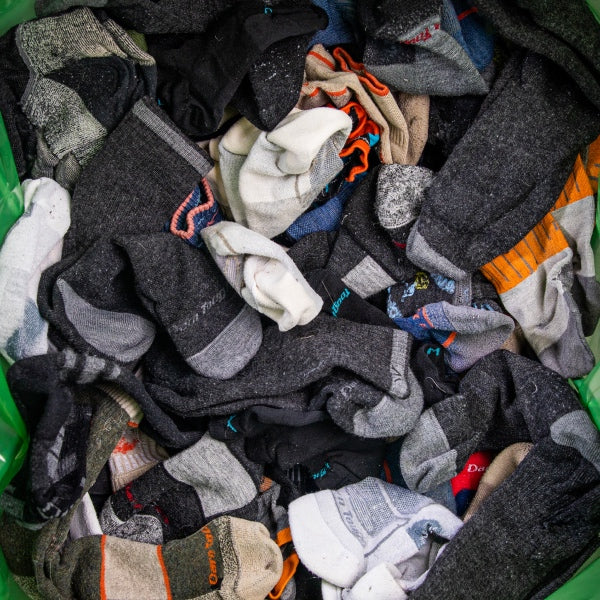 A giant pile of darn tough socks, all different styles and colors, all incredibly durable