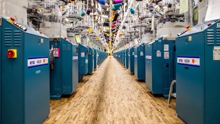 A row of knitting machines at the Mill in Darn Tough Vermont