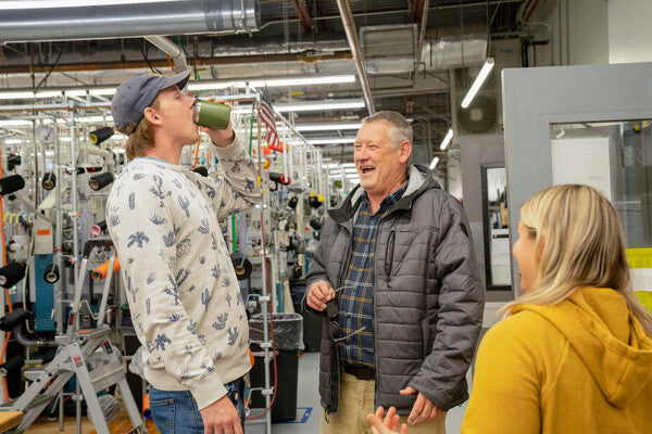 A group of Darn Tough employees chatting and laughing at the Mill