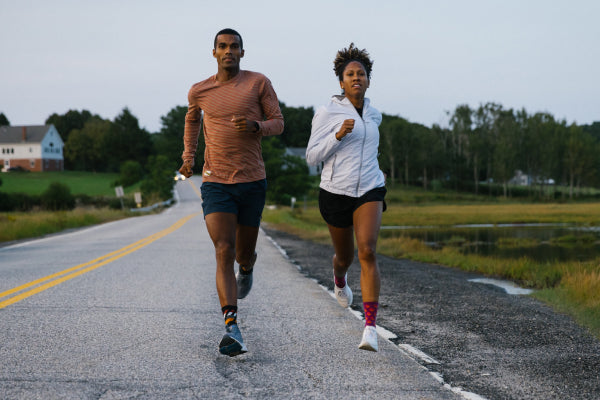 Two runners coming toward the camera going full speed