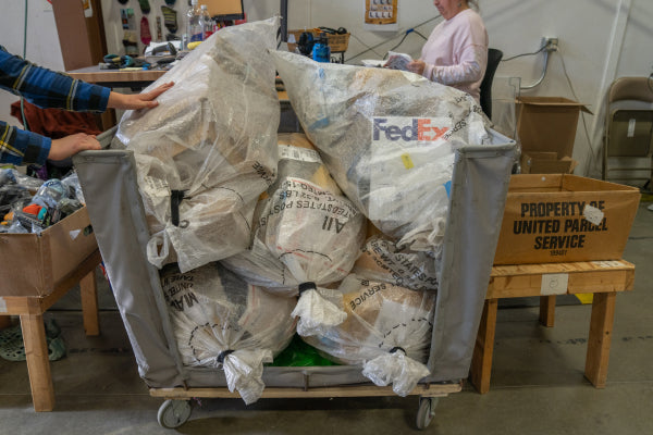 Hands reaching to take a bag off the pile of sock mail