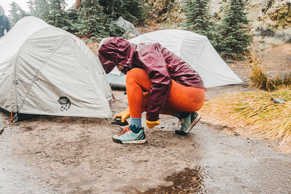 Hiker in the rain standing in puddles in merino wool moisture wicking socks