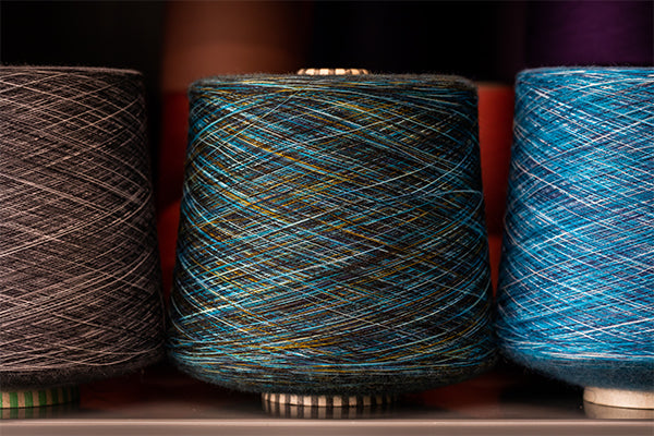 Super fine merino wool yarns or threads on a cone (it makes really soft socks)