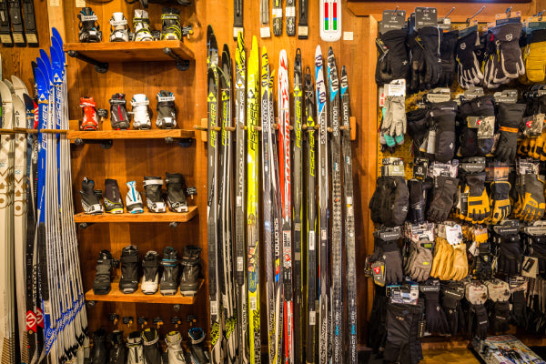 A wall covered in wool socks and nordic skis