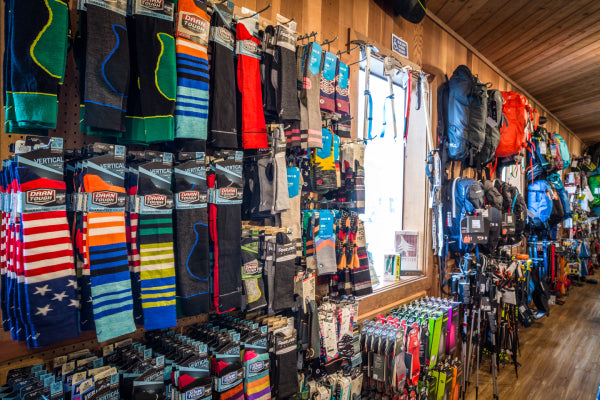 Alpenglow Sports wall covered in Darn Tough socks