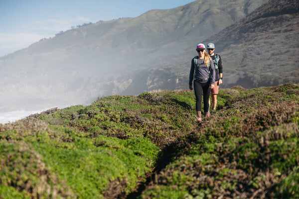 Two people hiking along the California Coastline