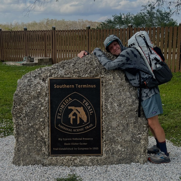 Cory hugging the rock that represents the southern terminus of the Florida Trail