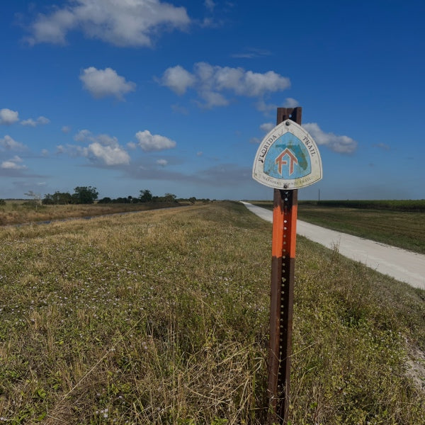 A Florida Scenic Trail marker as the trail winds through a field